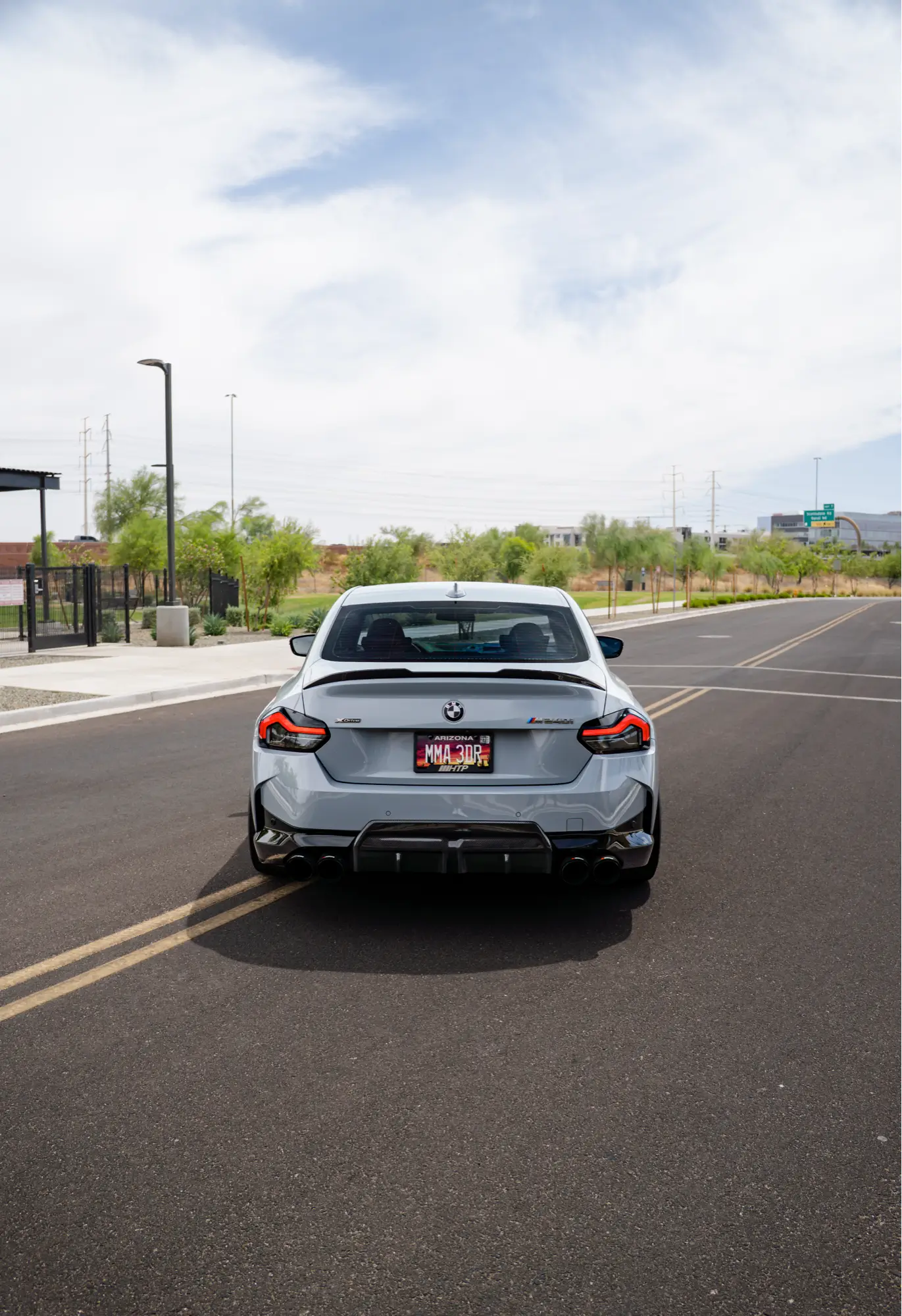 Rear view of a grey BMW M240i (G42) with an HTP Motorsport plate frame.