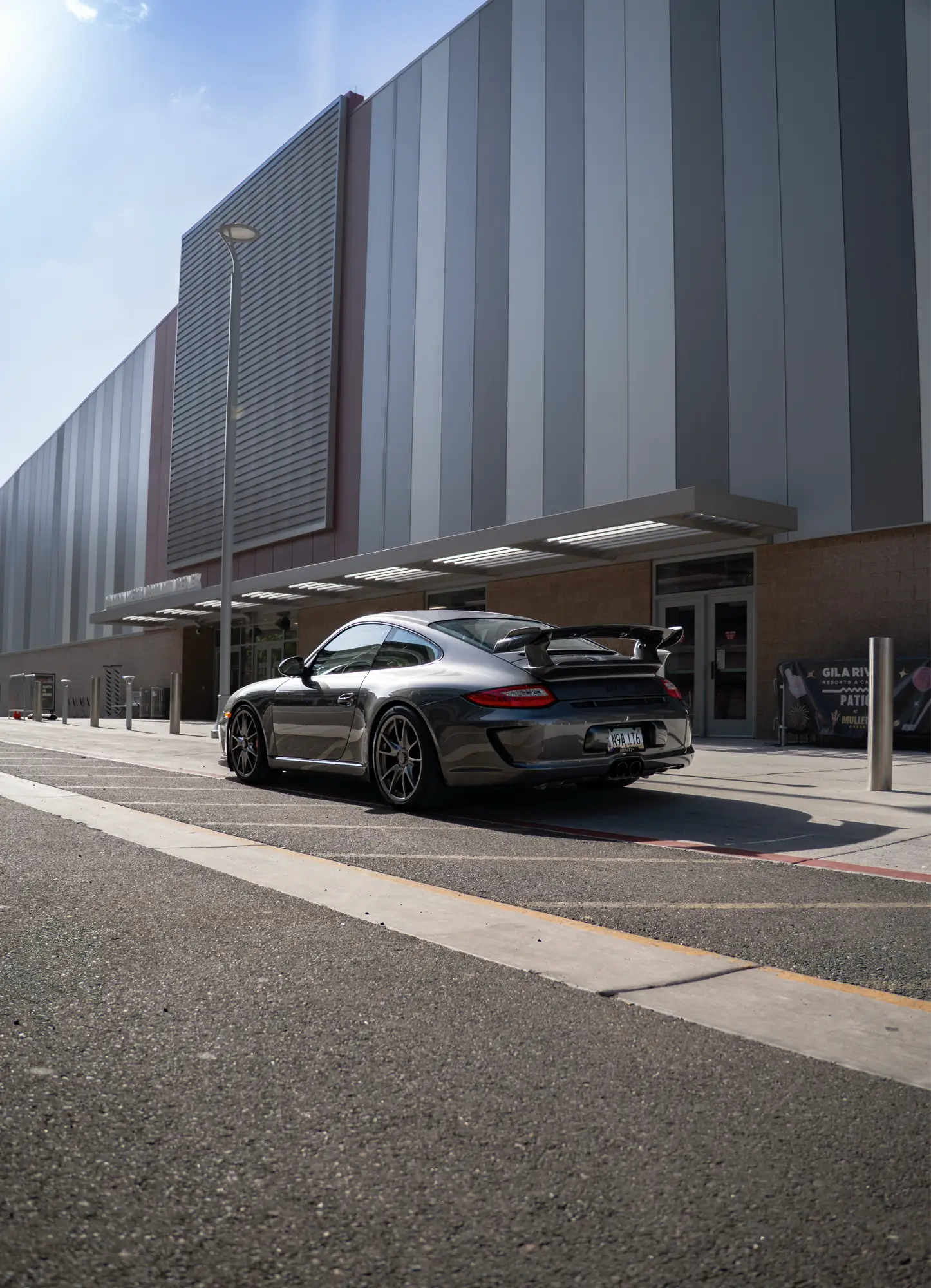 Grey Porsche 911 (997) GT3 shown rear three-quarter in a plaza.