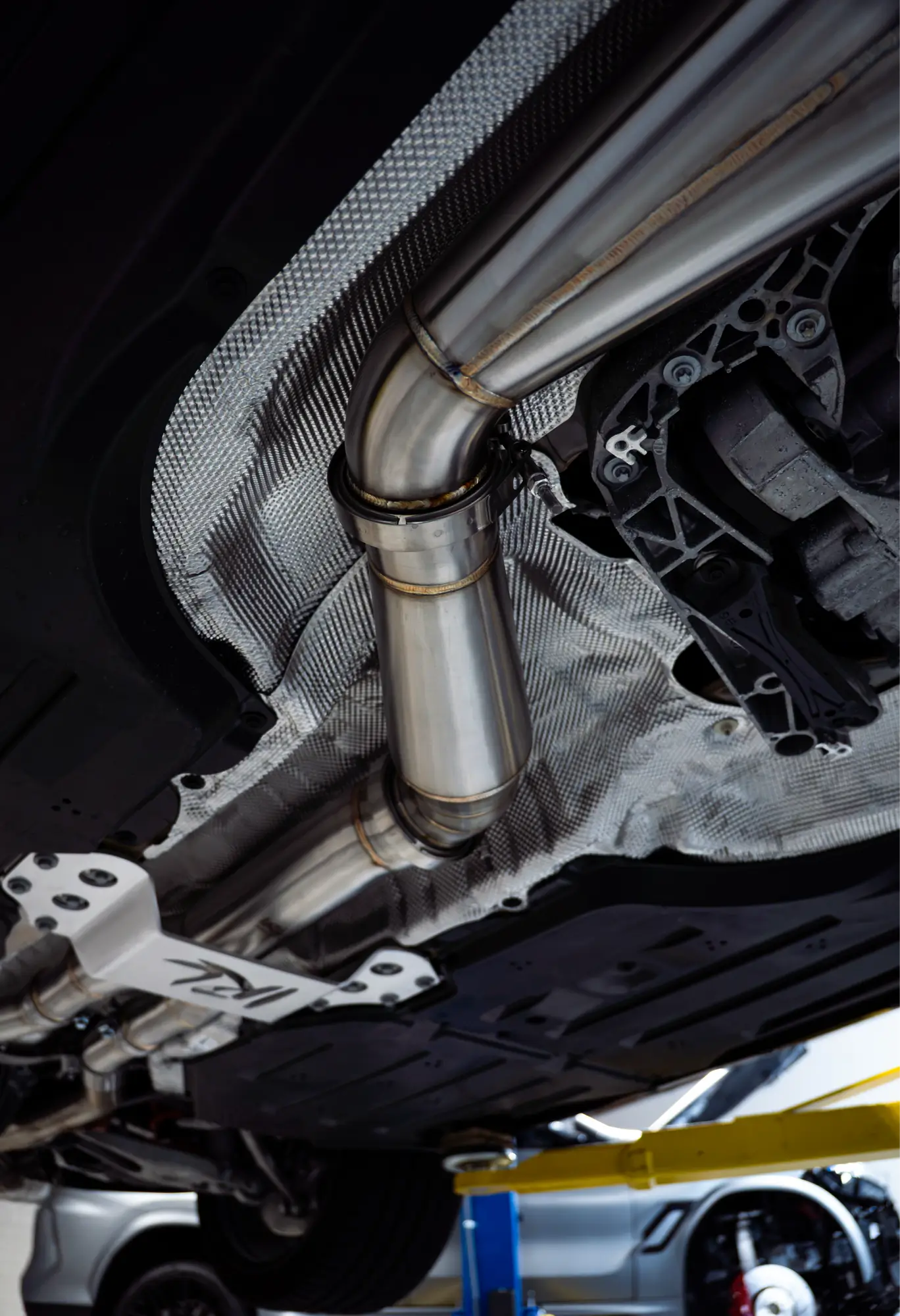 Close-up of a VRSF exhaust downpipe from underneath the vehicle.